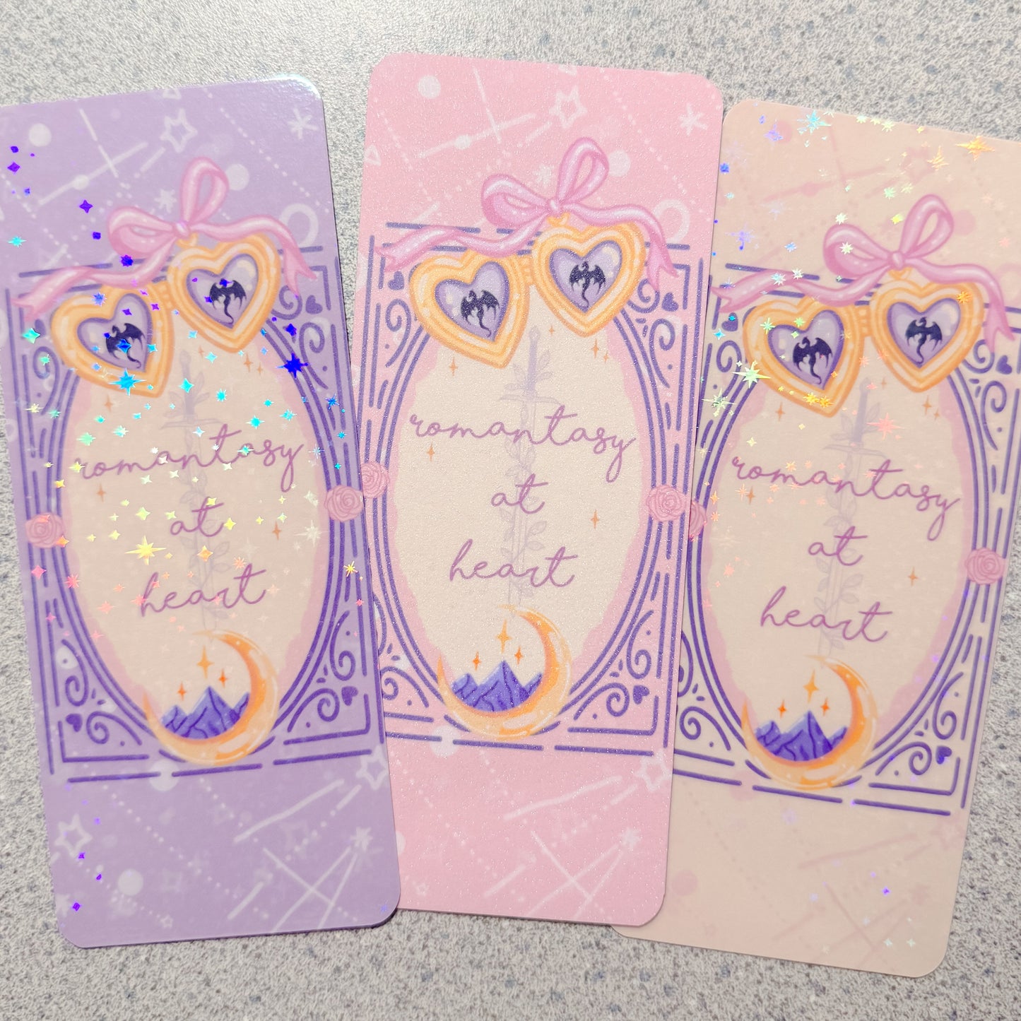 Three colorful bookmarks with decorative designs on a textured surface.
