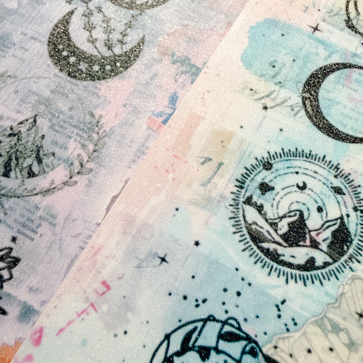 Close-up of patterned paper with celestial designs, including moons and stars.